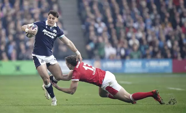 Scotland's Tom Jordan, left, tackled by Wales's Max Llewellyn during the Men's Six Nations rugby union match between Scotland and Wales the Murrayfield Stadium, Edinburgh, Saturday, March 8, 2025. (Jane Barlow/PA via AP)