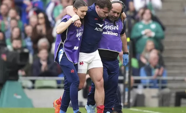 France's Antoine Dupont leaves the pitch after picking up an injury during the Six Nations rugby union match between Ireland and France, at Aviva Stadium, Dublin, Ireland, Saturday, March 8, 2025. (Niall Carson/PA via AP)