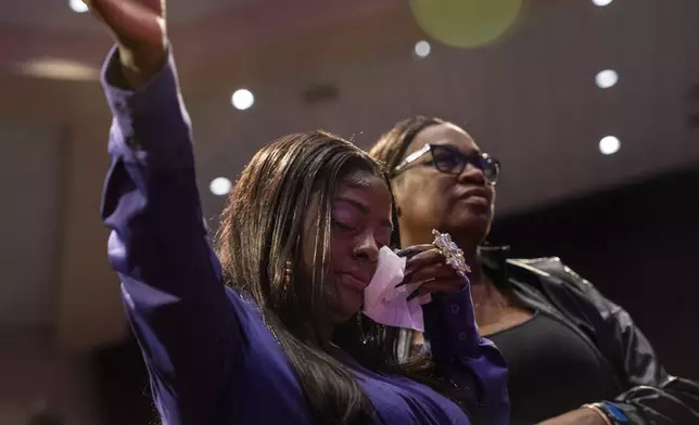 Diamond, daughter of Angie Stone, is supported through tears at her mother's memorial service, Friday, March 14, 2025, in Austell. Ga. (AP Photo/Olivia Bowdoin)