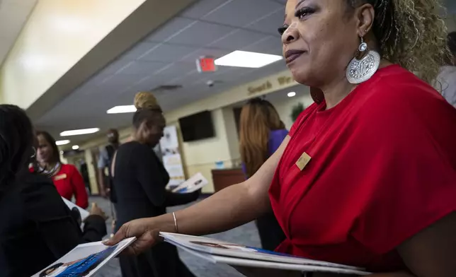 Programs are passed out before the memorial of singer and actress Angie Stone, Friday, March 14, 2025, in Austell. Ga. (AP Photo/Olivia Bowdoin)