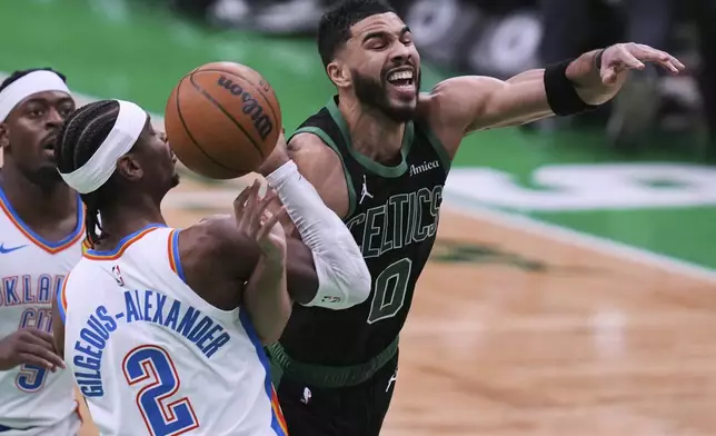 Boston Celtics forward Jayson Tatum (0) is fouled by Oklahoma City Thunder guard Shai Gilgeous-Alexander (2) during the second half of an NBA basketball game, Wednesday, March 12, 2025, in Boston. (AP Photo/Charles Krupa)