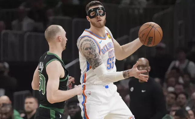 Oklahoma City Thunder center Isaiah Hartenstein (55) looks to pass while covered by Boston Celtics forward Sam Hauser, left, during the first half of an NBA basketball game, Wednesday, March 12, 2025, in Boston. (AP Photo/Charles Krupa)