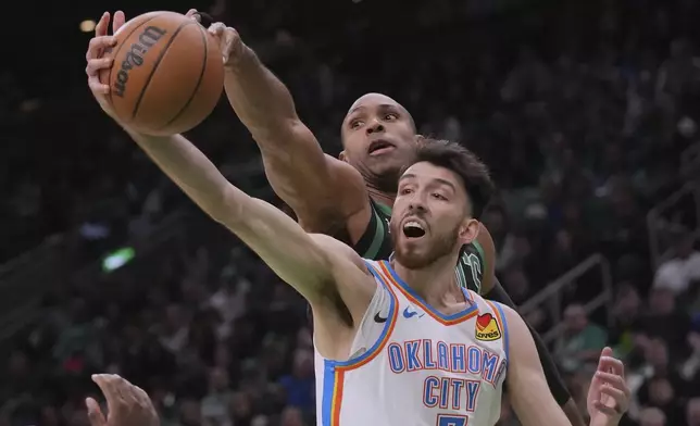 Boston Celtics center Al Horford, rear, battles for a rebound against Oklahoma City Thunder forward Chet Holmgren (7) during the first half of an NBA basketball game, Wednesday, March 12, 2025, in Boston. (AP Photo/Charles Krupa)