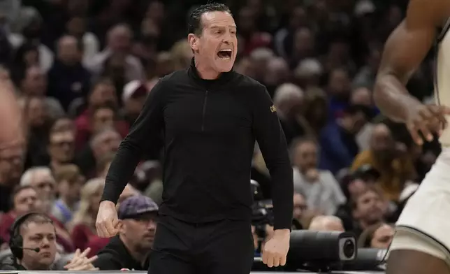 Cleveland Cavaliers head coach Kenny Atkinson shouts in the second half of an NBA basketball game against the Brooklyn Nets Tuesday, March 11, 2025, in Cleveland. (AP Photo/Sue Ogrocki)