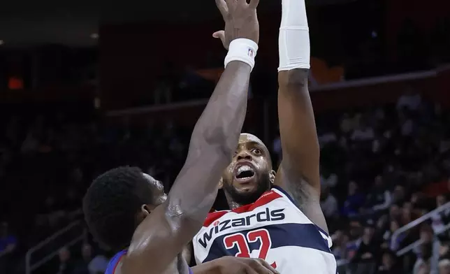 Washington Wizards forward Khris Middleton (32) takes a shot against Detroit Pistons center Jalen Duren during the first half of an NBA basketball game Tuesday, March 11, 2025, in Detroit. (AP Photo/Duane Burleson)