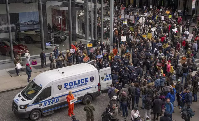 Demonstrators are arrested by NYPD officers during a protest against Elon Musk and Tesla outside of a Tesla showroom, Saturday, March 01, 2025 in New York. (AP Photo/Adam Gray)