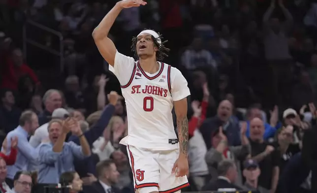 St. John's's Aaron Scott (0) celebrates after making a three-point shot during the second half of an NCAA college basketball game against the Marquette in the semifinals of the Big East tournament Friday, March 14, 2025, in New York. (AP Photo/Frank Franklin II)