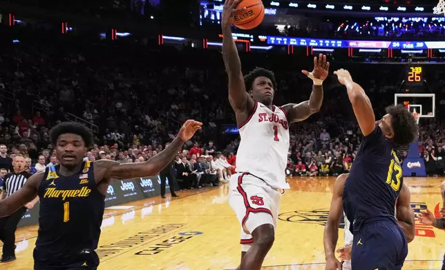 St. John's's Kadary Richmond (1) shoots over Marquette's Royce Parham (13) during the first half of an NCAA college basketball game in the semifinals of the Big East tournament Friday, March 14, 2025, in New York. (AP Photo/Frank Franklin II)