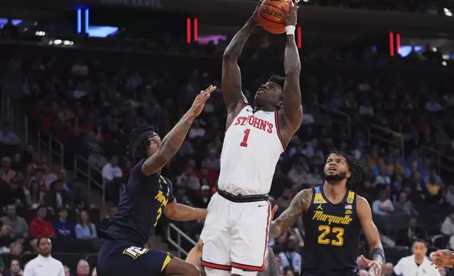 St. John's's Kadary Richmond (1) shoots over Marquette's Chase Ross (2) and David Joplin (23) during the first half of an NCAA college basketball game in the semifinals of the Big East tournament Friday, March 14, 2025, in New York. (AP Photo/Frank Franklin II)
