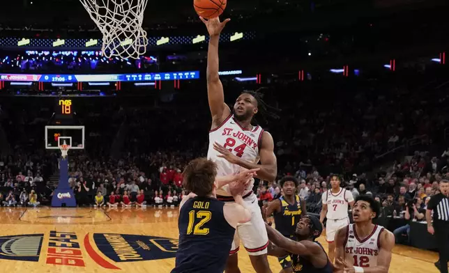 St. John's's Zuby Ejiofor (24) shoots over Marquette's Ben Gold (12) during the first half of an NCAA college basketball game in the semifinals of the Big East tournament Friday, March 14, 2025, in New York. (AP Photo/Frank Franklin II)