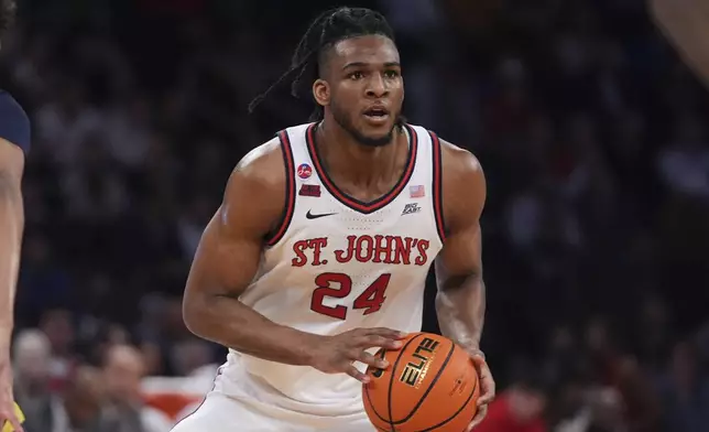 St. John's's Zuby Ejiofor (24) looks to pass during the first half of an NCAA college basketball game against the Marquette in the semifinals of the Big East tournament Friday, March 14, 2025, in New York. (AP Photo/Frank Franklin II)