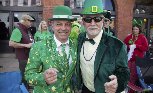 Todd Colvin, left, and Mike Pendley celebrate at the 22nd Annual World's Shortest St. Patrick's Day Parade on Monday, March 17, 2025, in Hot Springs, Ark. (AP Photo/Katie Adkins)