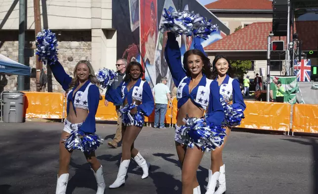 Dallas Cowboy cheerleaders wave to the crowd at the 22nd Annual World's Shortest St. Patrick's Day Parade on Monday, March 17, 2025, in Hot Springs, Ark. (AP Photo/Katie Adkins)
