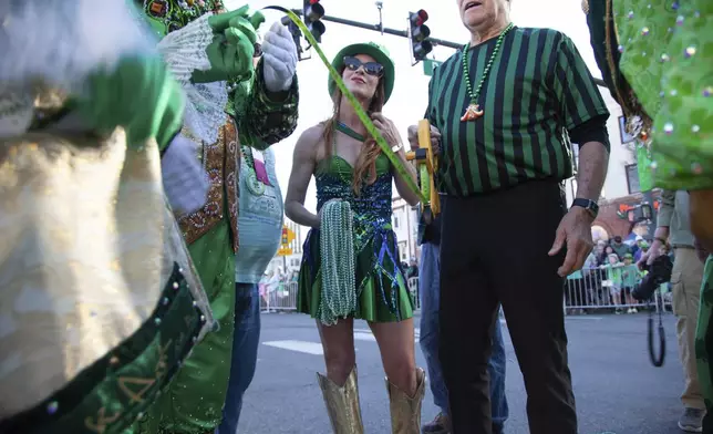 Officials discuss the logistics of measuring at the 22nd Annual World's Shortest St. Patrick's Day Parade on Monday, March 17, 2025, in Hot Springs, Ark. (AP Photo/Katie Adkins)