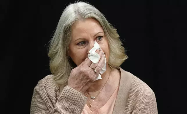 Karen Price sister of Ted Price reacts as a letter is read from Ted Price's daughter Brittany after the execution of Aaron Brian Gunches at the Arizona State Prison Wednesday, March 19, 2025 in Florence, Ariz. (AP Photo/Darryl Webb)