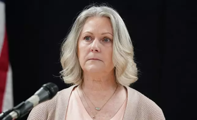 Karen Price sister of Ted Price takes a moment as she speaks about the execution of Aaron Brian Gunches at the Arizona State Prison Wednesday, March 19, 2025 in Florence, Ariz. (AP Photo/Darryl Webb)