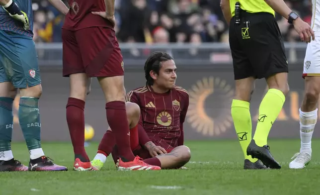 Roma's Paulo Dybala lies on the pitch during the Serie A soccer match between Roma and Cagliari at Rome's Olympic stadium, Sunday, March 16, 2025. (Fabrizio Corradetti/LaPresse via AP)