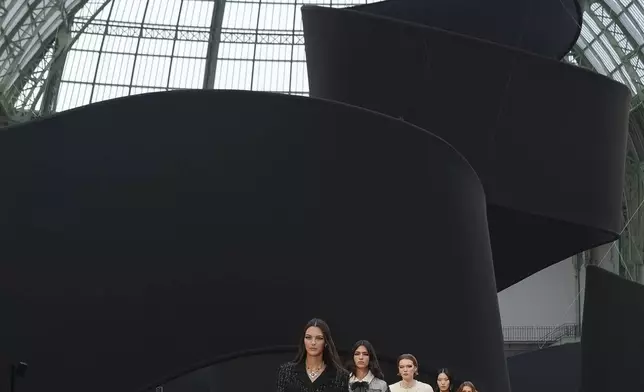 Vittoria Ceretti leads other models as they wear creations as part of the Chanel Fall/Winter 2025-2026 Womenswear collection presented Tuesday, March 11, 2025. in Paris. (Photo by Scott A Garfitt/Invision/AP)