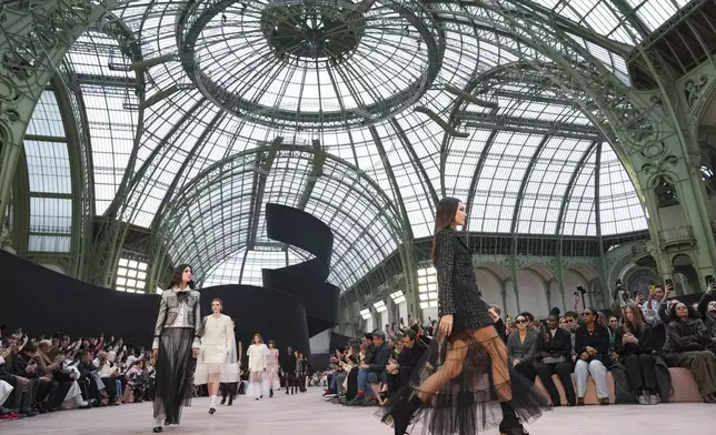 Vittoria Ceretti leads other models as they wear creations as part of the Chanel Fall/Winter 2025-2026 Womenswear collection presented Tuesday, March 11, 2025. in Paris. (Photo by Scott A Garfitt/Invision/AP)