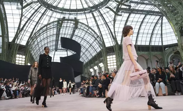Models wear creations as part of the Chanel Fall/Winter 2025-2026 Womenswear collection presented Tuesday, March 11, 2025. in Paris. (Photo by Scott A Garfitt/Invision/AP)