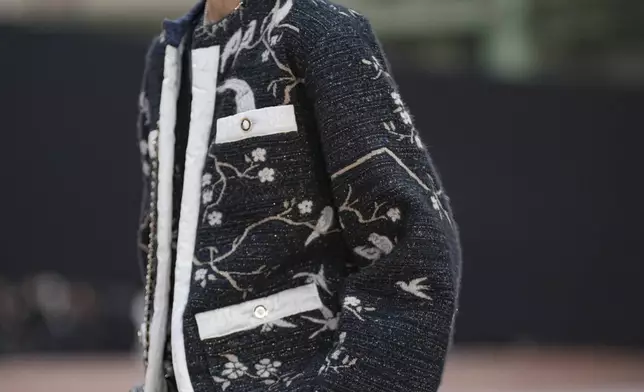 Liu Wen arrives for the the Chanel Fall/Winter 2025-2026 Womenswear collection presented Tuesday, March 11, 2025. in Paris. (AP Photo/Christophe Ena).