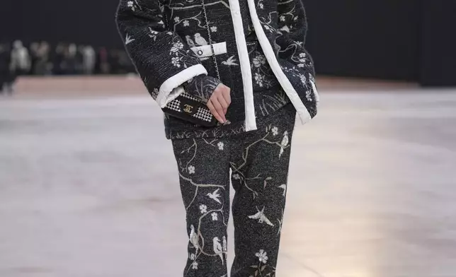 Liu Wen arrives for the the Chanel Fall/Winter 2025-2026 Womenswear collection presented Tuesday, March 11, 2025. in Paris. (AP Photo/Christophe Ena).