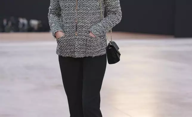Anna Mouglalis arrives for the the Chanel Fall/Winter 2025-2026 Womenswear collection presented Tuesday, March 11, 2025. in Paris. (AP Photo/Christophe Ena).