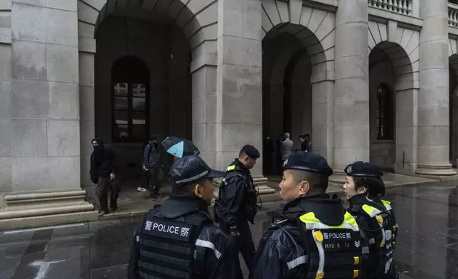 Police officers stand guard outside the Court of Final Appeal in Hong Kong, Thursday, March 6, 2025. Three former organizers of Hong Kong's annual vigil in remembrance of the 1989 Tiananmen Square crackdown won their bid at the top court on Thursday to overturn their conviction over their refusal to provide information to police, marking a rare victory for the city's pro-democracy activists. (AP Photo/Chan Long Hei)