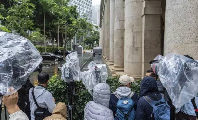 Members of the media wait outside the Court of Final Appeal in Hong Kong, Thursday, Mar 6, 2025. Three former organizers of Hong Kong's annual vigil in remembrance of the 1989 Tiananmen Square crackdown won their bid at the top court on Thursday to overturn their conviction over their refusal to provide information to police, marking a rare victory for the city's pro-democracy activists. (AP Photo/Chan Long Hei)