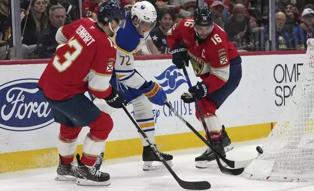 Buffalo Sabres center Tage Thompson (72) goes for the puck against Florida Panthers center Sam Reinhart (13) and center Aleksander Barkov (16) during the second period of an NHL hockey game, Saturday, March 8, 2025, in Sunrise, Fla. (AP Photo/Lynne Sladky)