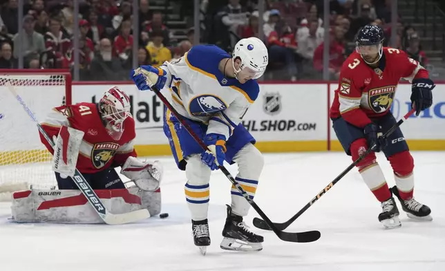 Florida Panthers goaltender Vitek Vanecek (41) and defenseman Seth Jones (3) defend the goal against Buffalo Sabres center Joshua Norris (13) during the first period of an NHL hockey game, Saturday, March 8, 2025, in Sunrise, Fla. (AP Photo/Lynne Sladky)