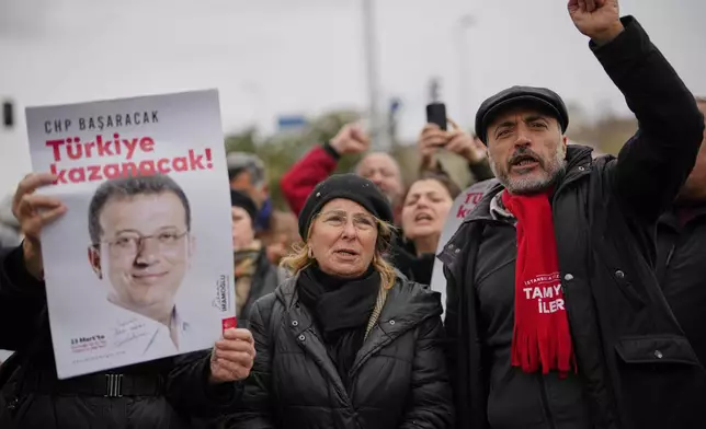 People chant slogans as they protest outside the Vatan Security Department, where Istanbul Mayor Ekrem Imamoglu is expected to be taken following his arrest in Istanbul, Turkey, on Wednesday, March 19, 2025. (AP Photo/Emrah Gurel)