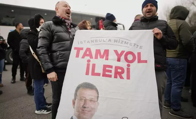 People chant slogans as they protest the arrest of Istanbul Mayor Ekrem Imamoglu in Istanbul, Turkey, Wednesday, March 19, 2025. (AP Photo/Emrah Gurel)
