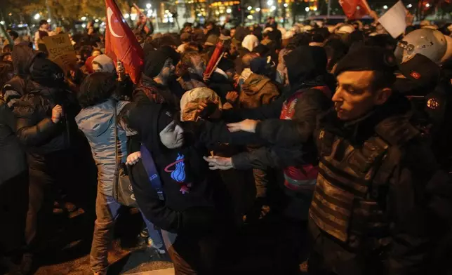 Protesters scuffle with anti-riot police outside City Hall while protesting the arrest of Istanbul Mayor Ekrem Imamoglu in Istanbul, Turkey, Wednesday, March 19, 2025. (AP Photo/Emrah Gurel)