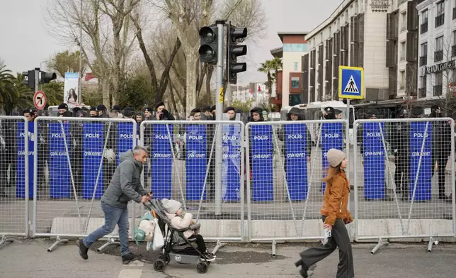 Police cordon off the roads leading to the Vatan Security Department, where Istanbul Mayor Ekrem Imamoglu is expected to be taken following his arrest in Istanbul, Turkey, on Wednesday, March 19, 2025. (AP Photo/Emrah Gurel)