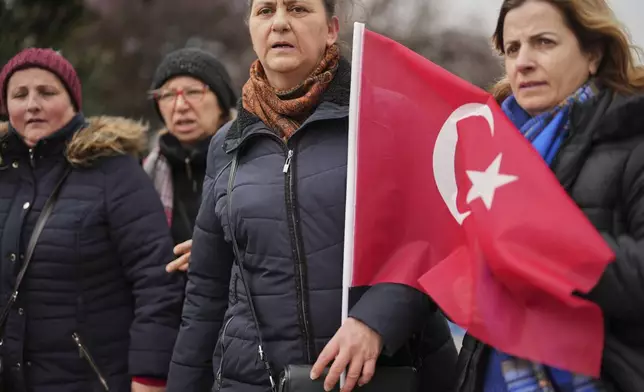 Women stand in protest outside the City Hall following the arrest of Istanbul Mayor Ekrem Imamoglu in Istanbul, Turkey, Wednesday, March 19, 2025. (AP Photo/Francisco Seco)