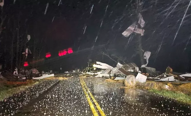 Debris covers the road during a severe storm passed the area north of Seymour, Mo., in Webster County late Friday, March 14, 2025. (Trooper Austin James/Missouri State Highway Patrol via AP)
