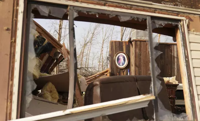 A image of Jesus hangs displayed inside a home belonging to Tim Scott, who was standing near the image when his house was destroyed by a severe storm the evening before, Saturday, March 15, 2025, in Wayne County, Mo. (AP Photo/Jeff Roberson)