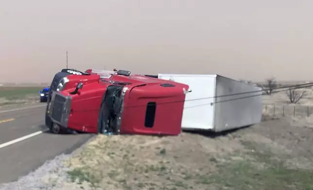 This photo provided by the Oklahoma Highway Patrol shows a tractor-trailer overturned on highway US 183 just south of Hobart, Oklahoma on Thursday, March 13, 2025. (Oklahoma Highway Patrol via AP)