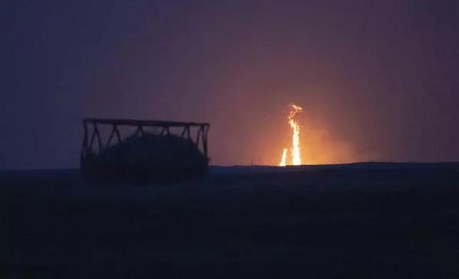 A wildfire burns through a field Friday, March 14, 2025, south of Langston, Okla. (AP Photo/Alonzo Adams)