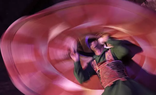 A dervish spins during a religious performance to mark the holy month of Ramadan at Sultan Qansuh al-Ghuri complex in Cairo, Egypt, Wednesday, March 12, 2025. (AP Photo/Amr Nabil)