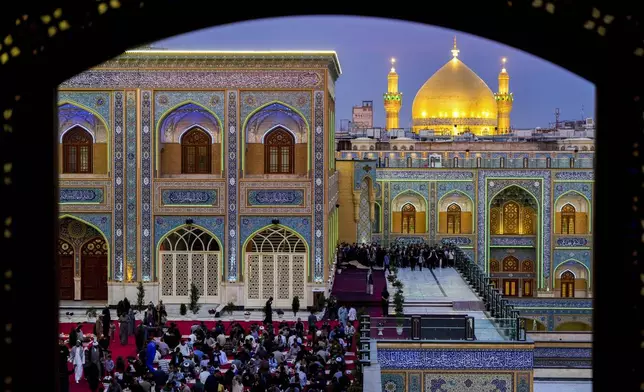 Shiites break the fast during the Islamic holy month of Ramadan in the Imam Ali shrine in Najaf, Iraq, Saturday, March 15, 2025. (AP Photo/Anmar Khalil)