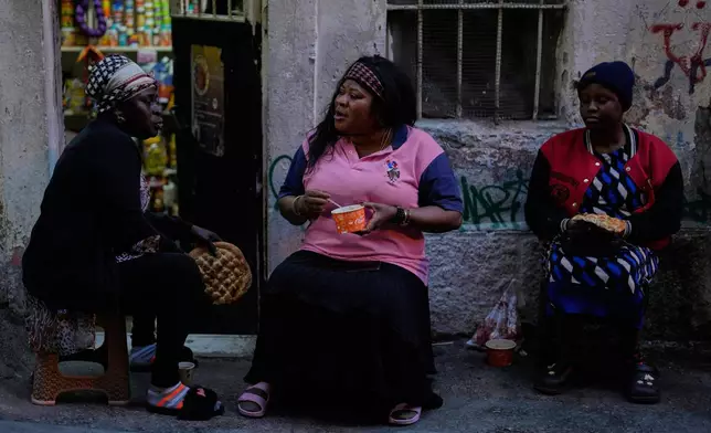 Women have their Iftar, the Ramadan fast-breaking meal, organised by the local community in a poor neighborhood in Istanbul, Saturday March 15, 2025. (AP Photo/Khalil Hamra)