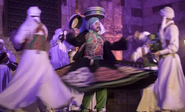 Dervishes spin during a religious performance to mark the holy month of Ramadan at Sultan Qansuh al-Ghuri complex in Cairo, Egypt, Wednesday, March 12, 2025. (AP Photo/Amr Nabil)