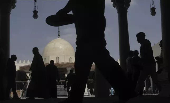 Muslim worshippers leave Friday prayers during the holy fasting month of Ramadan, at Amr ibn al-Aas Mosque in Cairo, Egypt, Friday, March 7, 2025. (AP Photo/Amr Nabil)