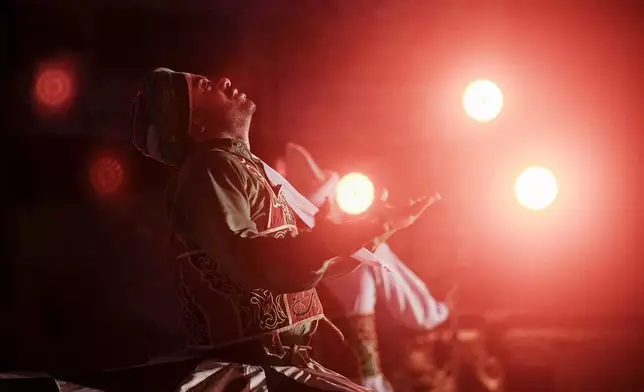 A dervish spins during a religious performance to mark the holy month of Ramadan at Sultan Qansuh al-Ghuri complex in Cairo, Egypt, Wednesday, March 12, 2025. (AP Photo/Amr Nabil)