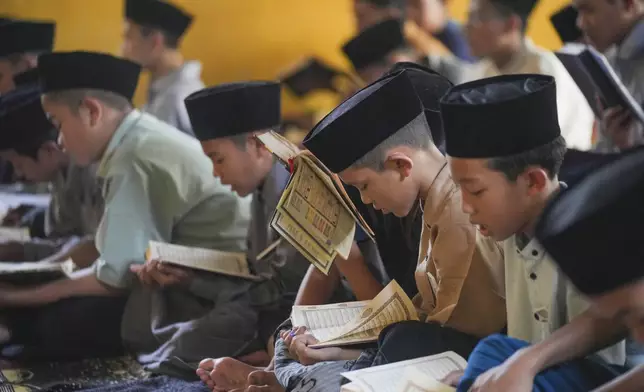 Students read the Quran during the holy fasting month of Ramadan at Daarut Tarqiyah Primago Islamic Boarding School in Depok on the outskirts of Jakarta, Indonesia, Thursday, March 6, 2025. (AP Photo/Tatan Syuflana)