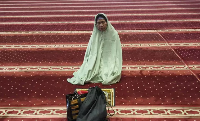 A woman prays during the holy fasting month of Ramadan at Istiqlal Mosque in Jakarta, Indonesia, Friday, March 7, 2025. (AP Photo/Tatan Syuflana)