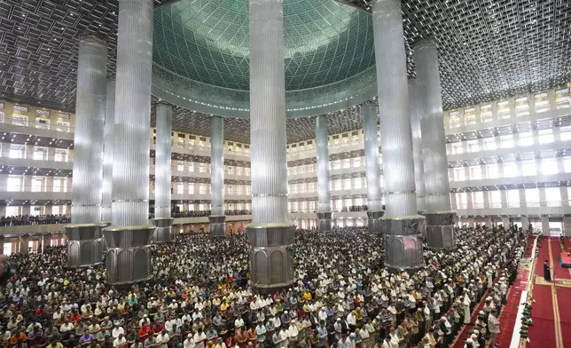 Muslim men perform during the first Friday prayer of the fasting month of Ramadan at Istiqlal Mosque in Jakarta, Indonesia, Friday, March 7, 2025. (AP Photo/Tatan Syuflana)