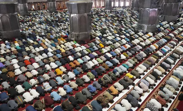 Muslim men perform during the first Friday prayer of the fasting month of Ramadan at Istiqlal Mosque in Jakarta, Indonesia, Friday, March 7, 2025. (AP Photo/Tatan Syuflana)
